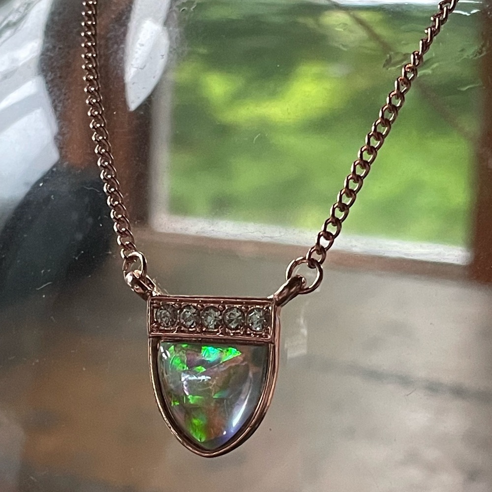 Rose gold tone necklace with opal like stone.